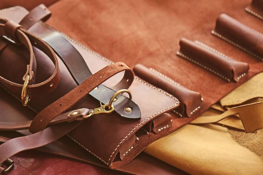 Detailed close-up of premium Leather Goods, showcasing intricate stitching and brass hardware.